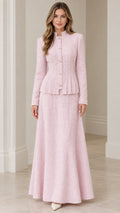 Front view of model wearing blush pink tweed peplum jacket and matching maxi skirt suit set