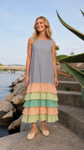 Model wearing blue striped tiered ruffle maxi dress, front view