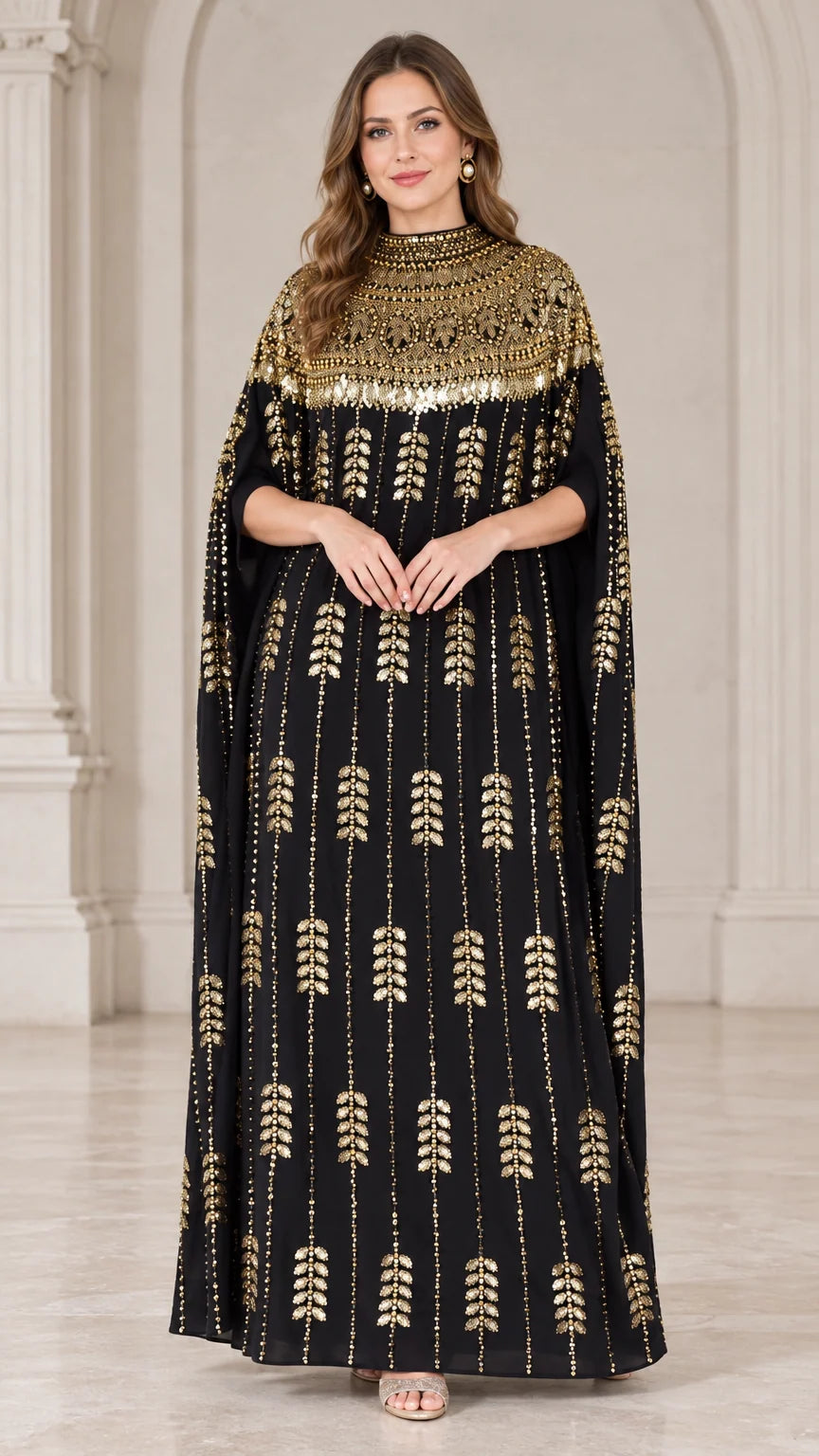 Front view of black kaftan maxi dress with gold sequin embellished neckline and cape sleeves