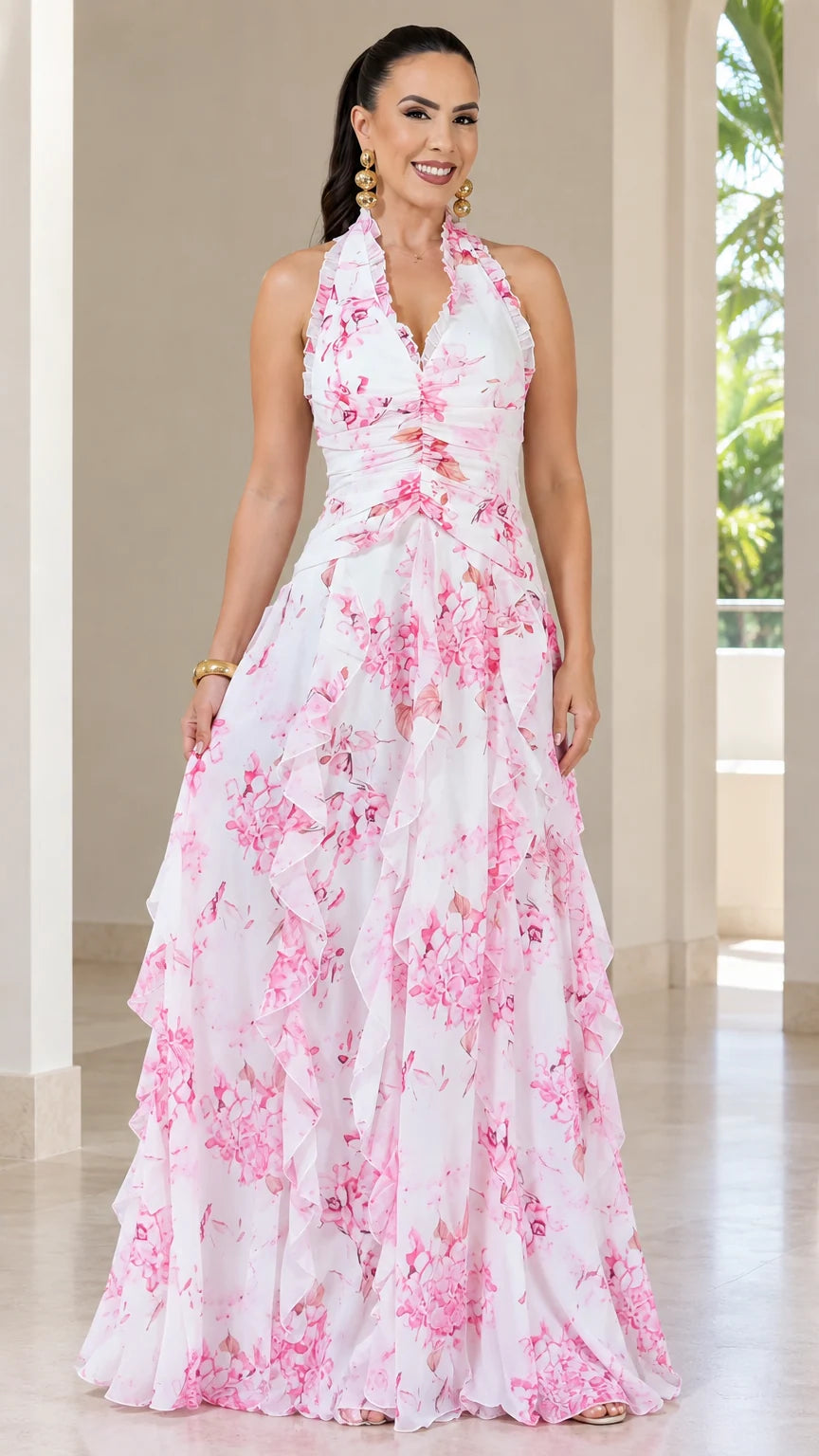 Front view of woman wearing white floral halter neck tiered maxi dress