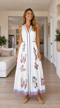Front view of woman wearing white butterfly print maxi dress