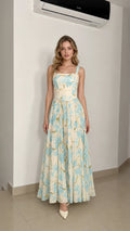 Model wearing ivory floral maxi dress from the front