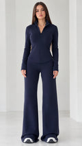 Full front view of women's navy blue quarter-zip top and wide-leg flare pants set
