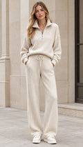 Front full view of woman wearing cream ribbed knit 2-piece lounge set with half-zip top and wide-leg pants