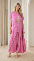 Full front view of model wearing fuchsia pink short-sleeve tunic top with overlapping tulip hem and matching wide-leg pants