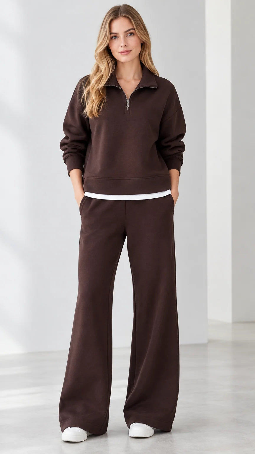 Front view of model wearing brown half-zip sweatshirt and wide-leg sweatpants matching set