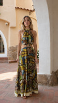 Full front view of model wearing brown printed halter neck cutout maxi dress