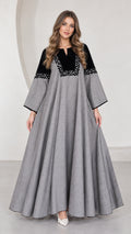 Front full-length view of woman wearing grey embroidered contrast yoke maxi dress