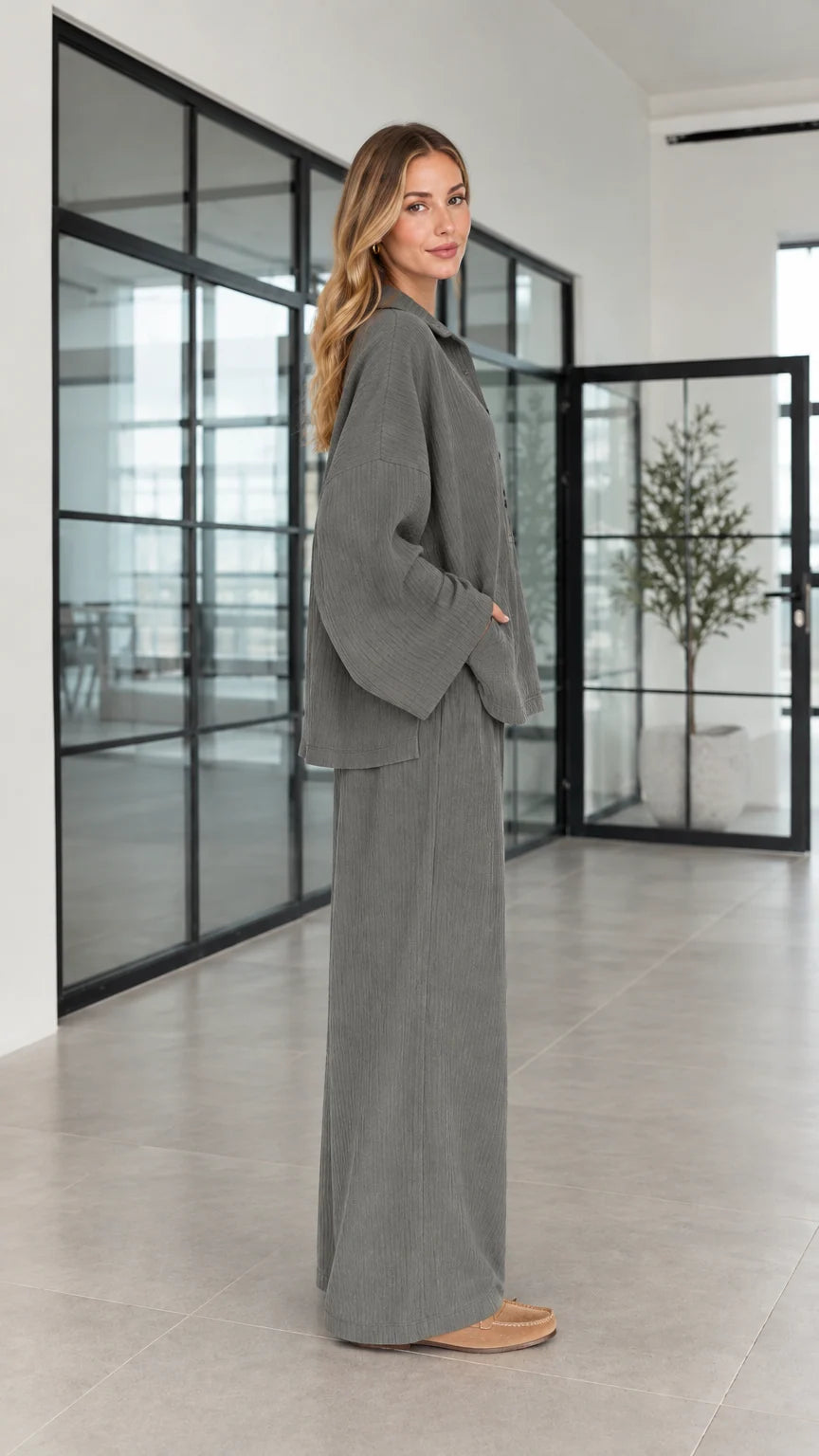 Side profile of women's charcoal grey oversized matching pants set