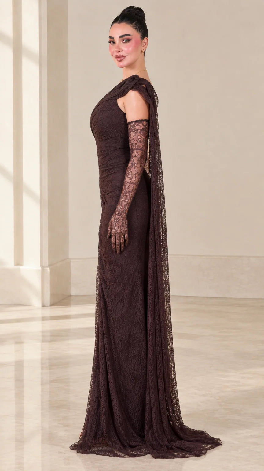 Side profile of dark brown lace formal gown showing sleek draped fit and floor length cape