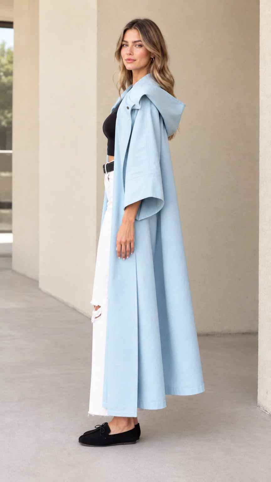 Side profile view of sky blue longline hooded trench coat