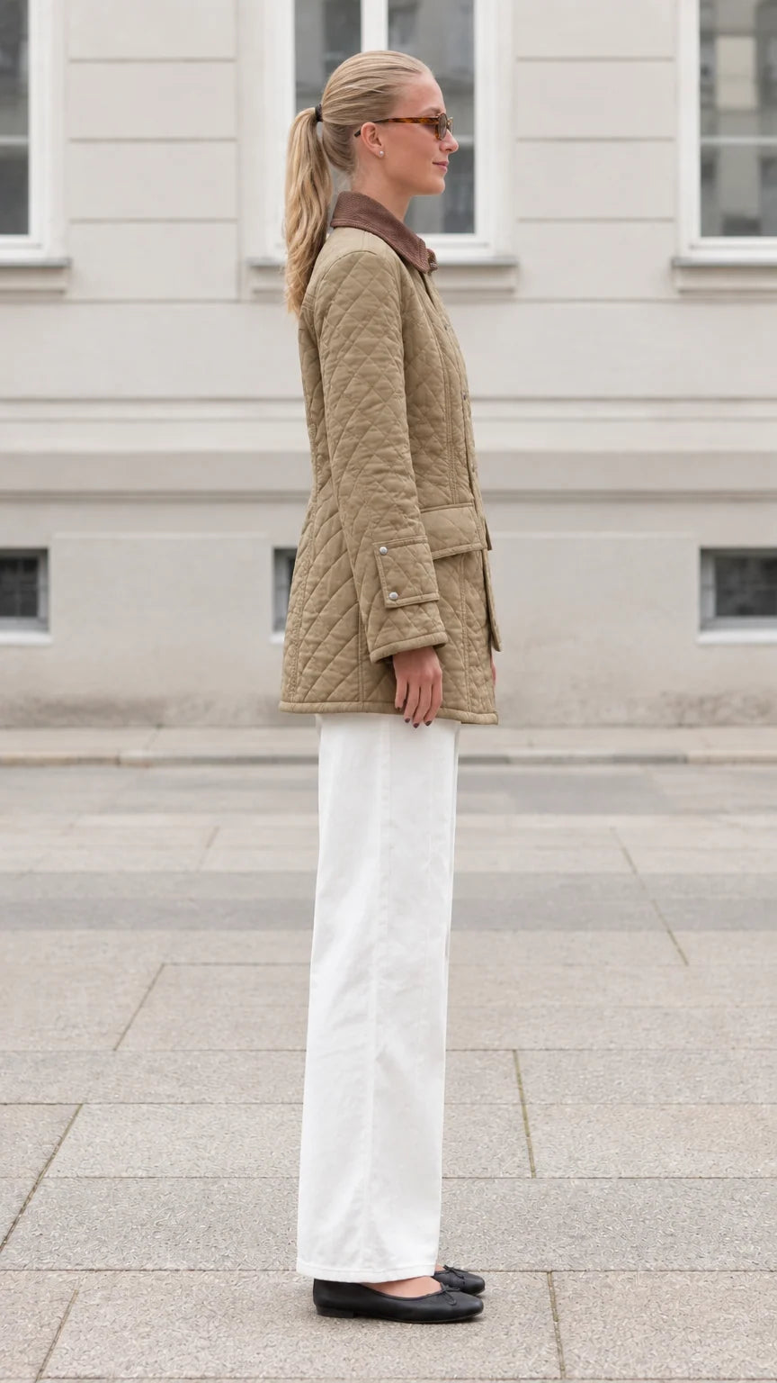 Side profile view of woman wearing khaki quilted field jacket