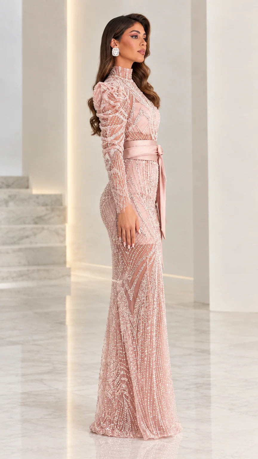 Side angle view of model in dusty pink embellished long-sleeve evening gown