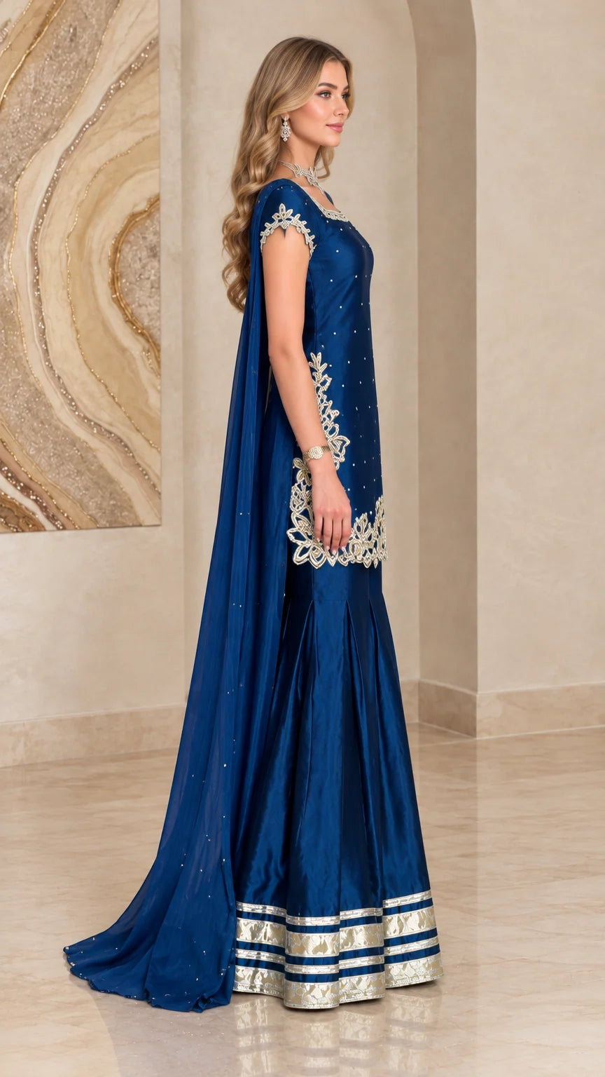 Side profile of royal blue cape sharara suit showing dramatic length