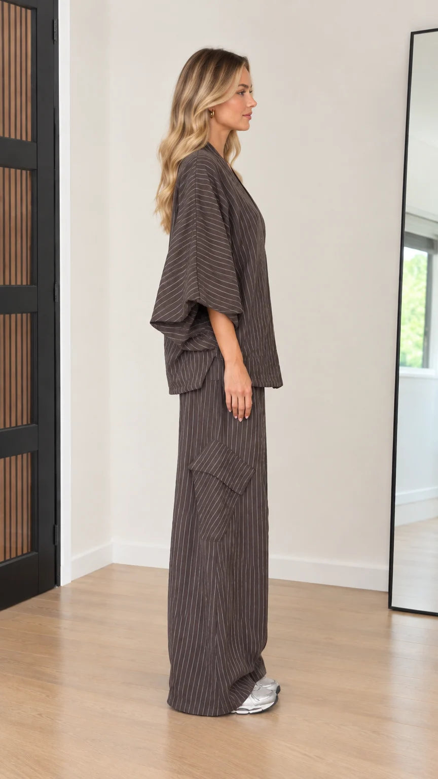 Side profile of women's relaxed pinstripe matching lounge set in mocha brown