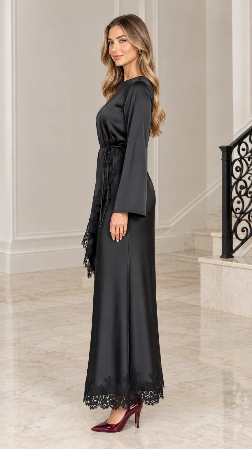 Side profile view of black satin long sleeve maxi gown