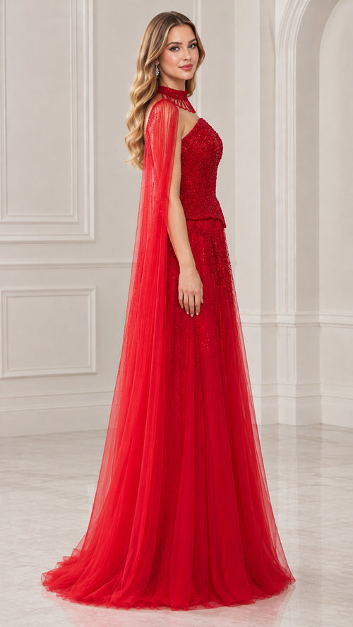 Side profile view of red formal cape gown showing sweeping tulle length