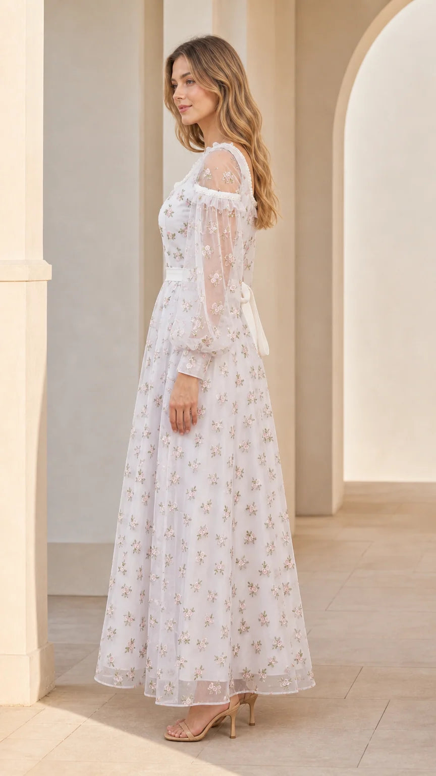 Side angle view of model in white floral embroidered tulle gown