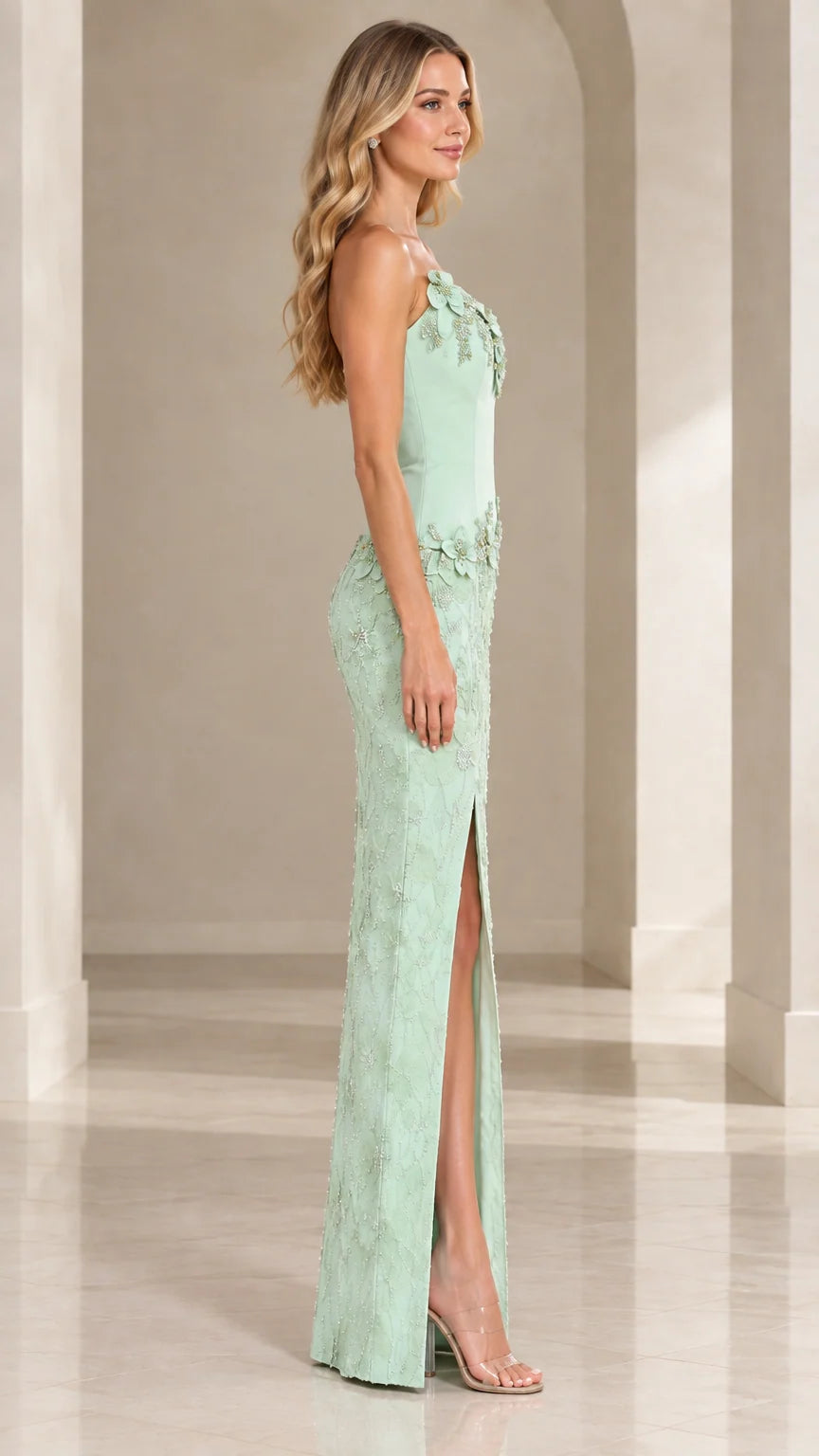 Side profile of mint green asymmetric formal gown showing side slit