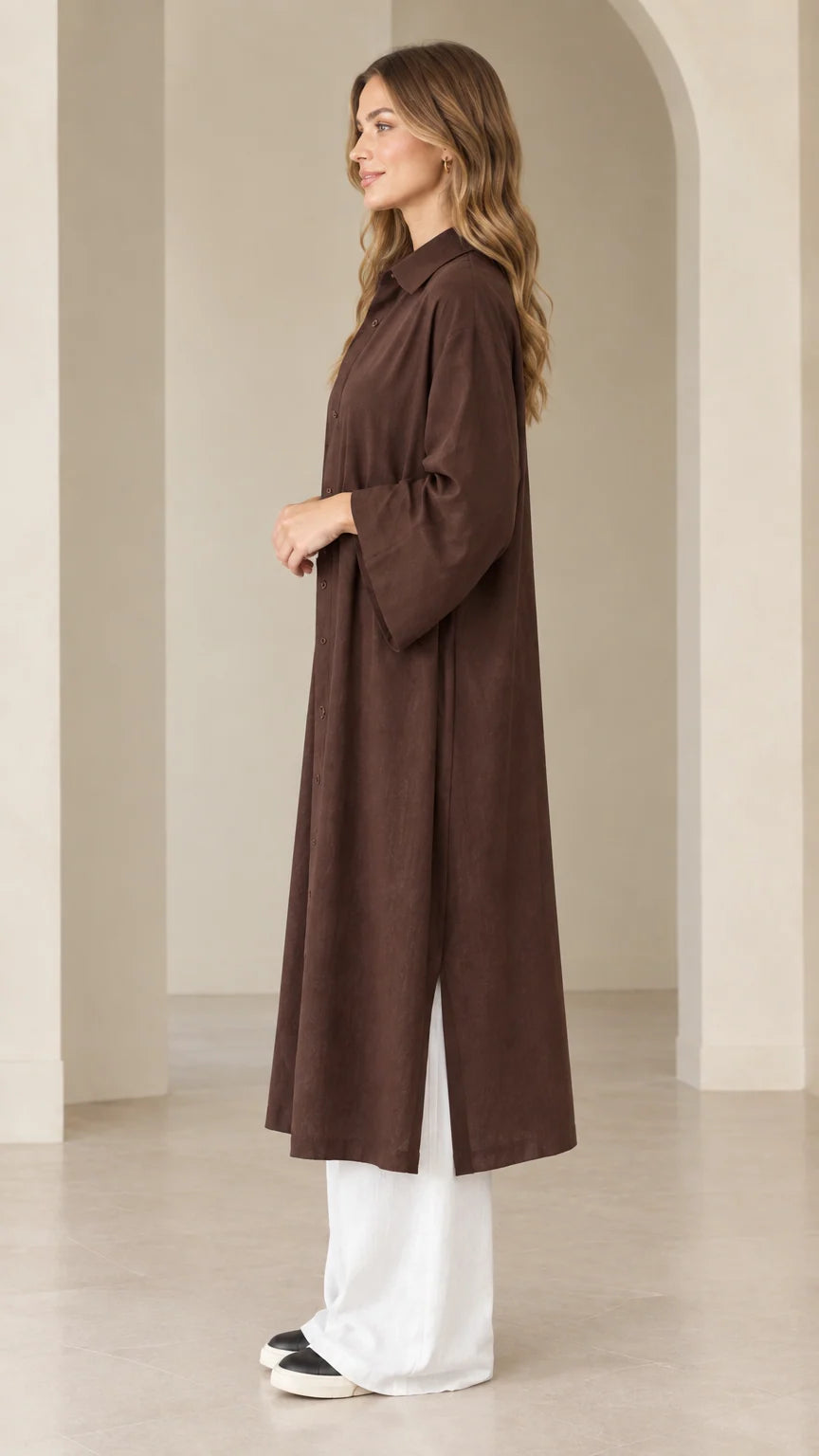 Side view of dark brown duster dress showcasing side slit hem and relaxed fit