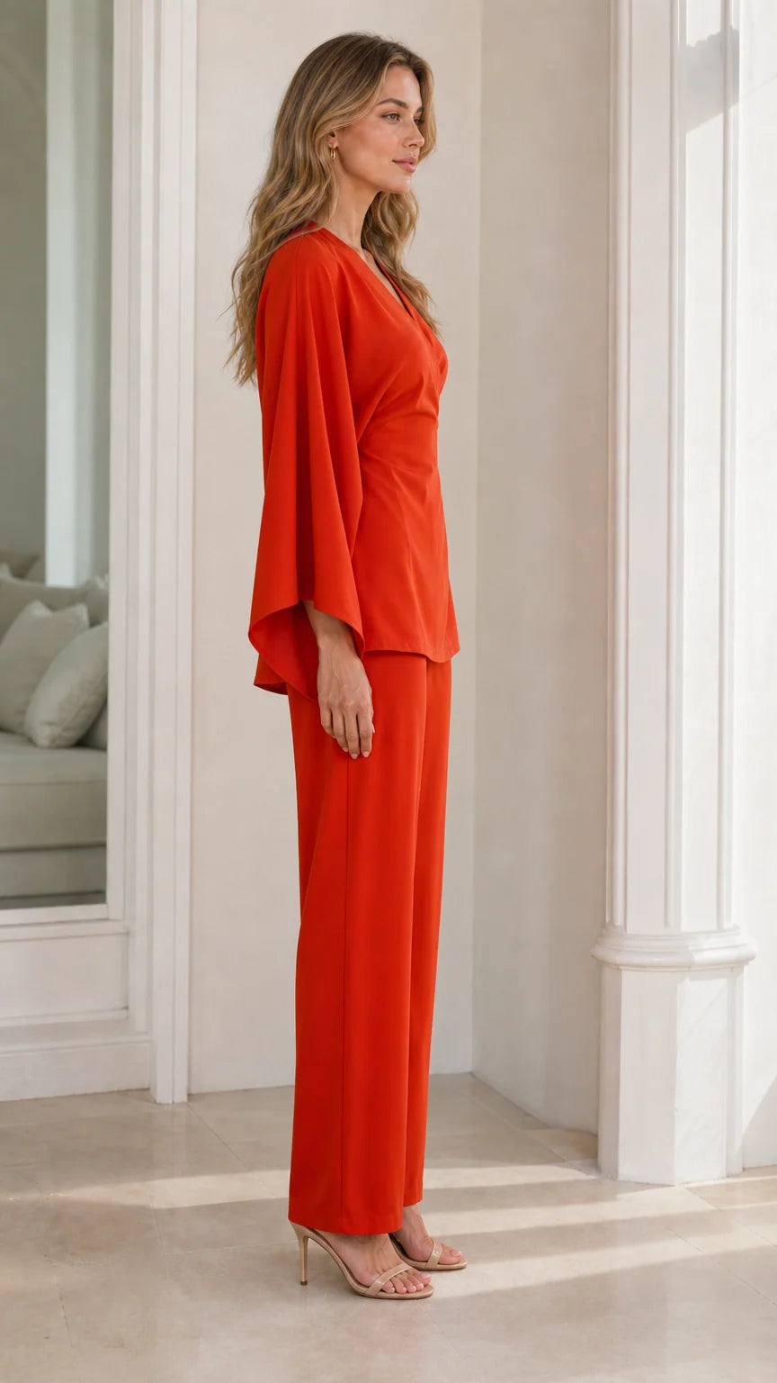 Side angle view of model wearing burnt orange draped sleeve pant set