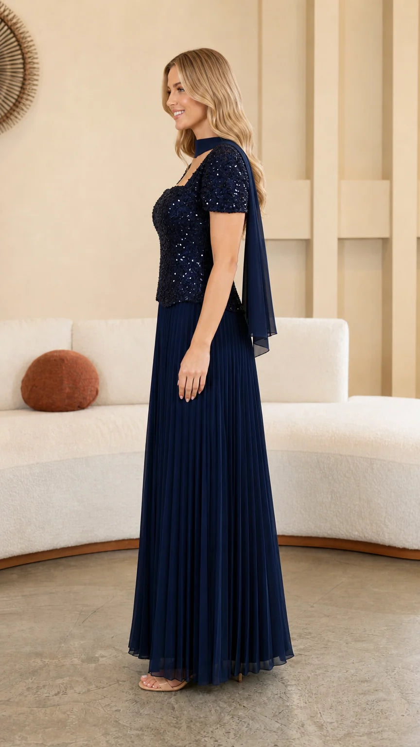 Model wearing Navy Blue formal pleated maxi gown side profile view