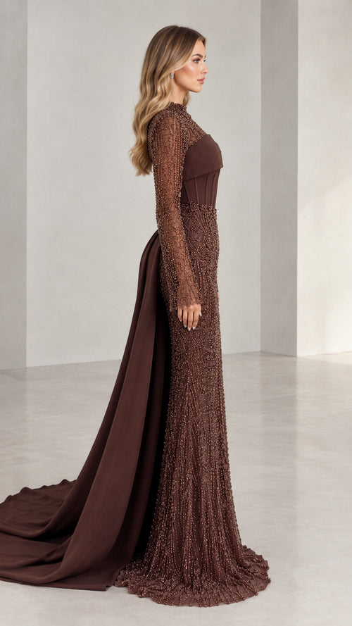 Side profile view of woman modeling brown beaded long sleeve formal gown with sweeping train