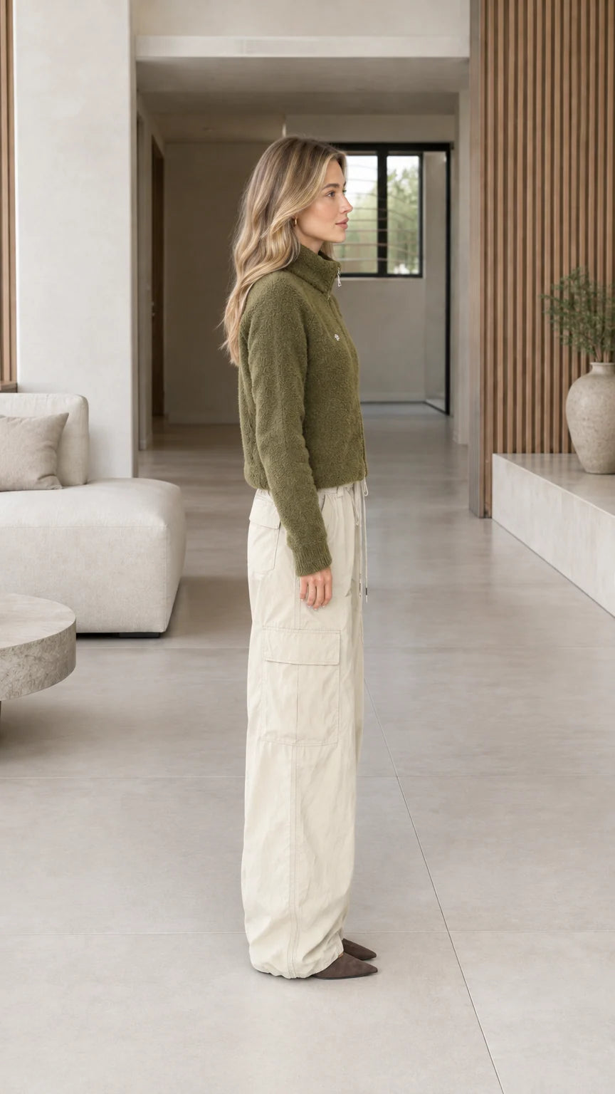 Side profile view of model wearing olive green cropped fleece jacket