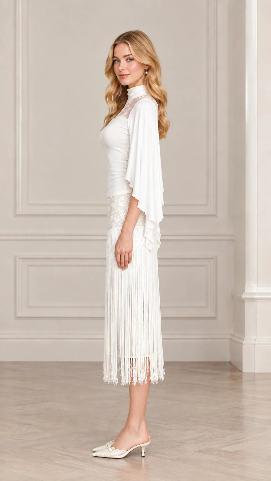 Side view of model in elegant white lace capelet fringe cocktail dress