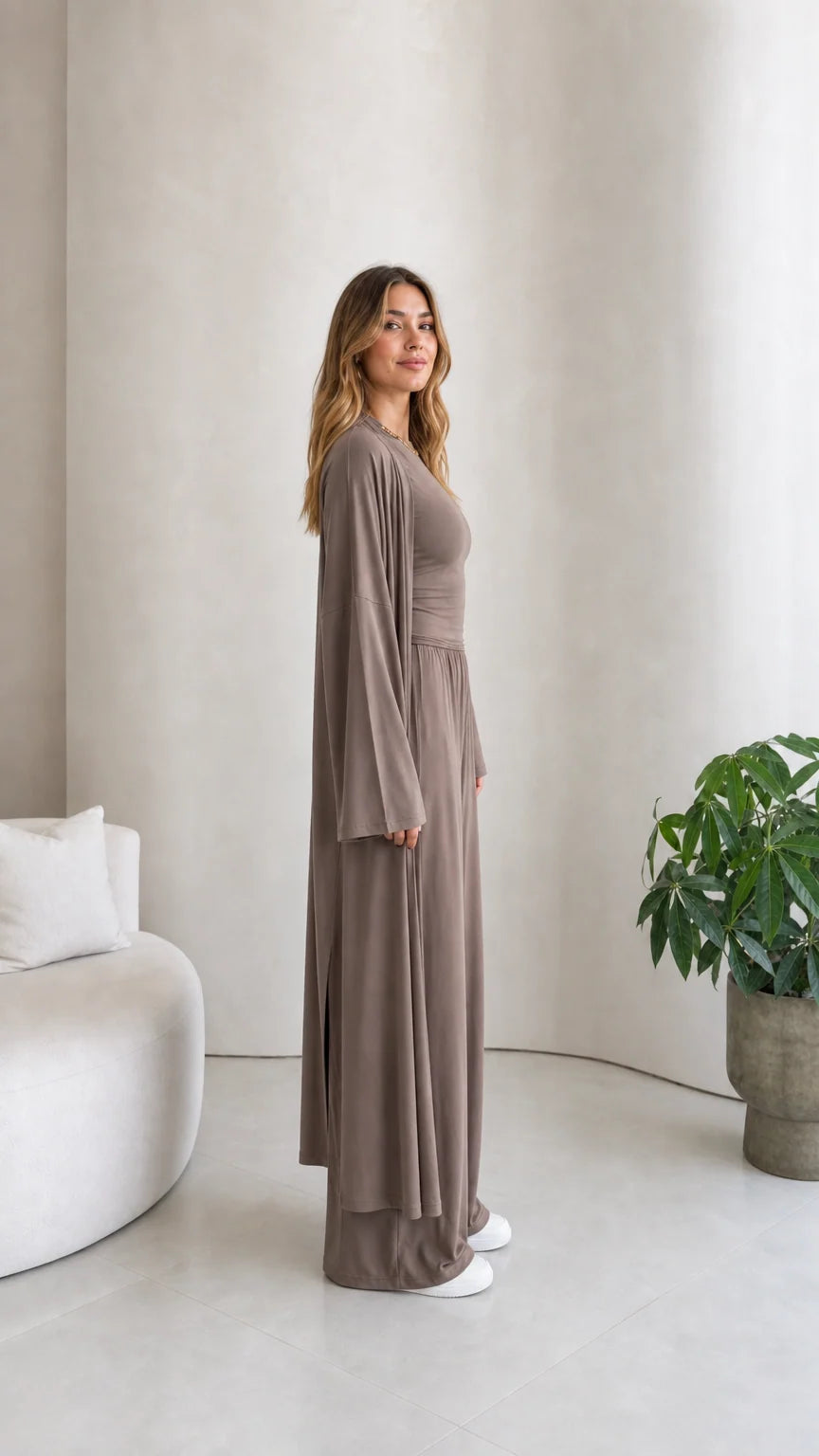 Side profile view of model wearing the taupe 3-piece duster cardigan matching set