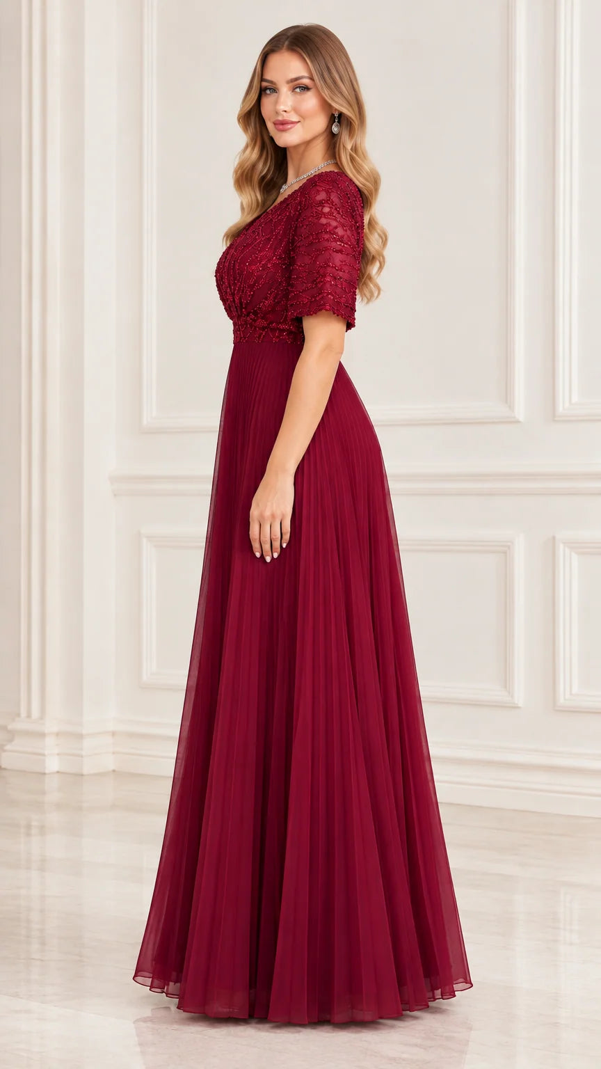 Side profile view of burgundy pleated A-line formal gown with short sleeves