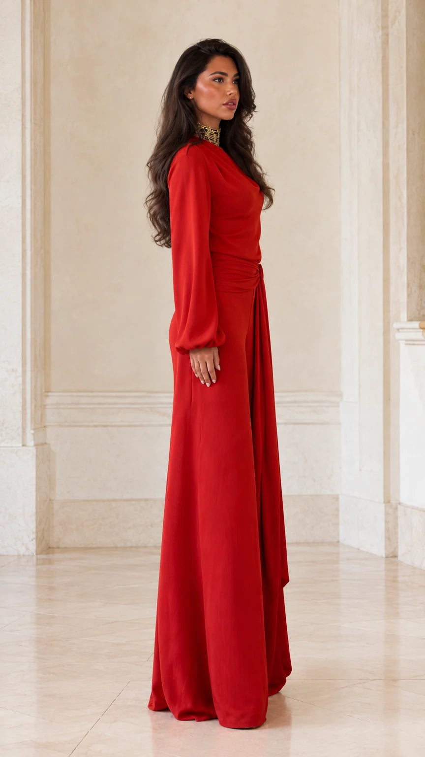 Side profile view of woman modeling red asymmetric wide-leg evening jumpsuit