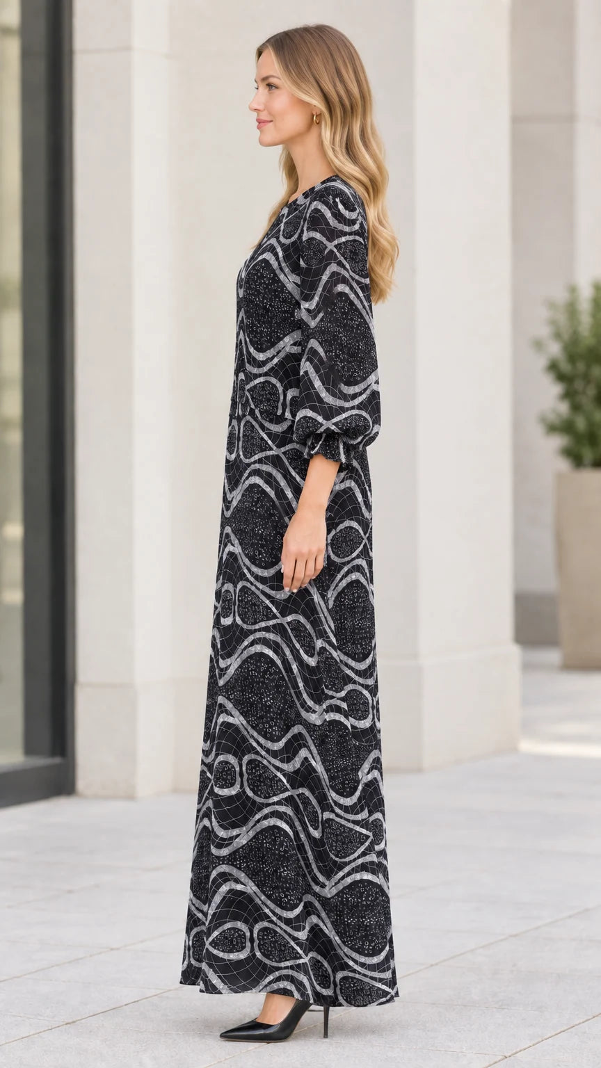 Side profile of model wearing black geometric wave print maxi dress