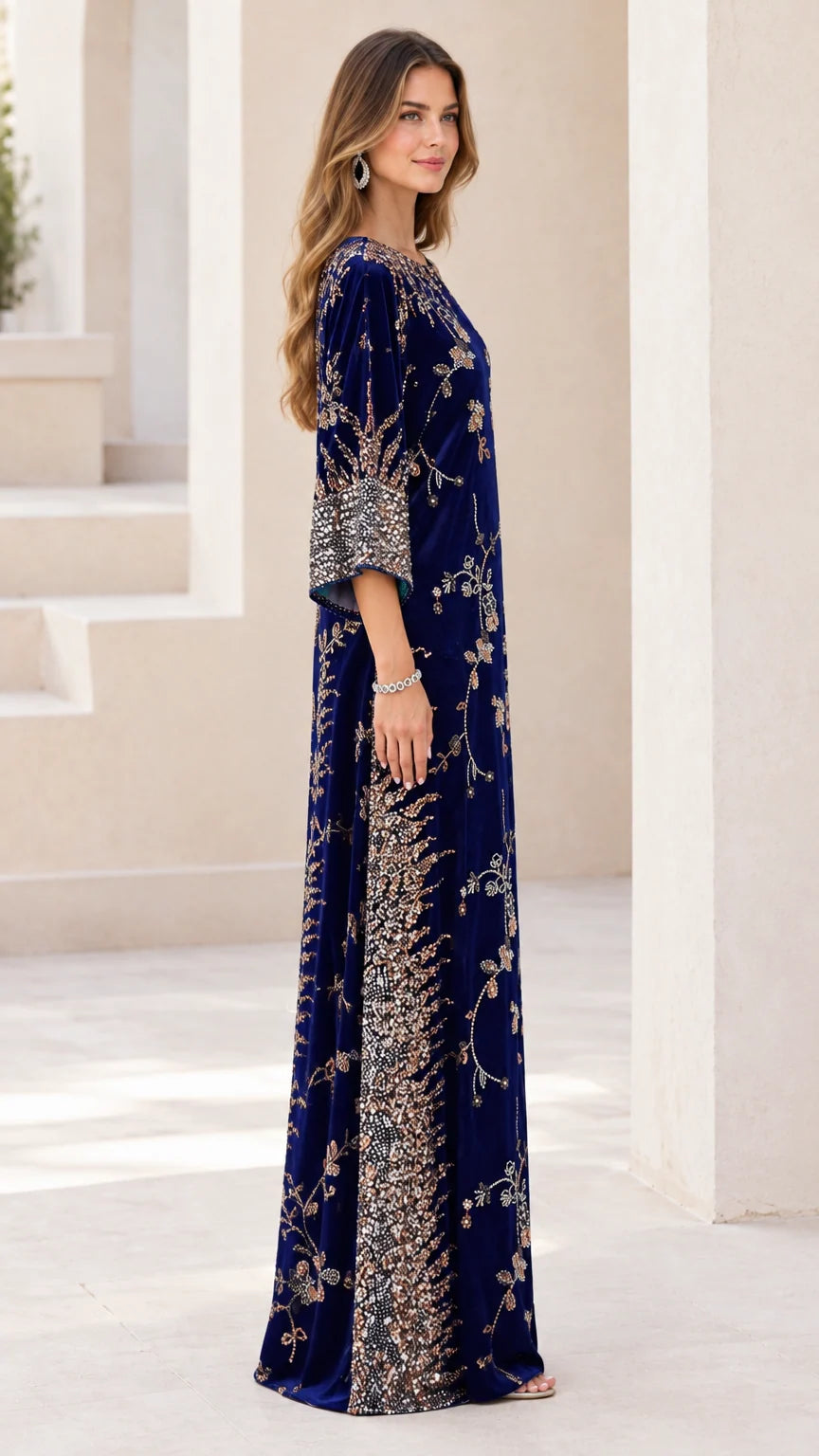 Side profile of woman wearing navy blue beaded velvet evening gown