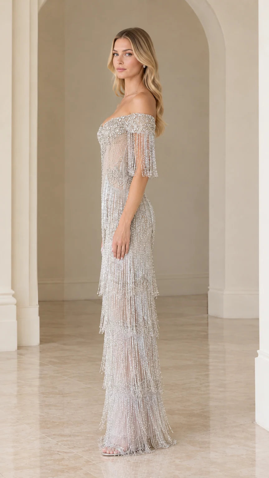 Side profile of woman in elegant silver tiered fringe formal dress