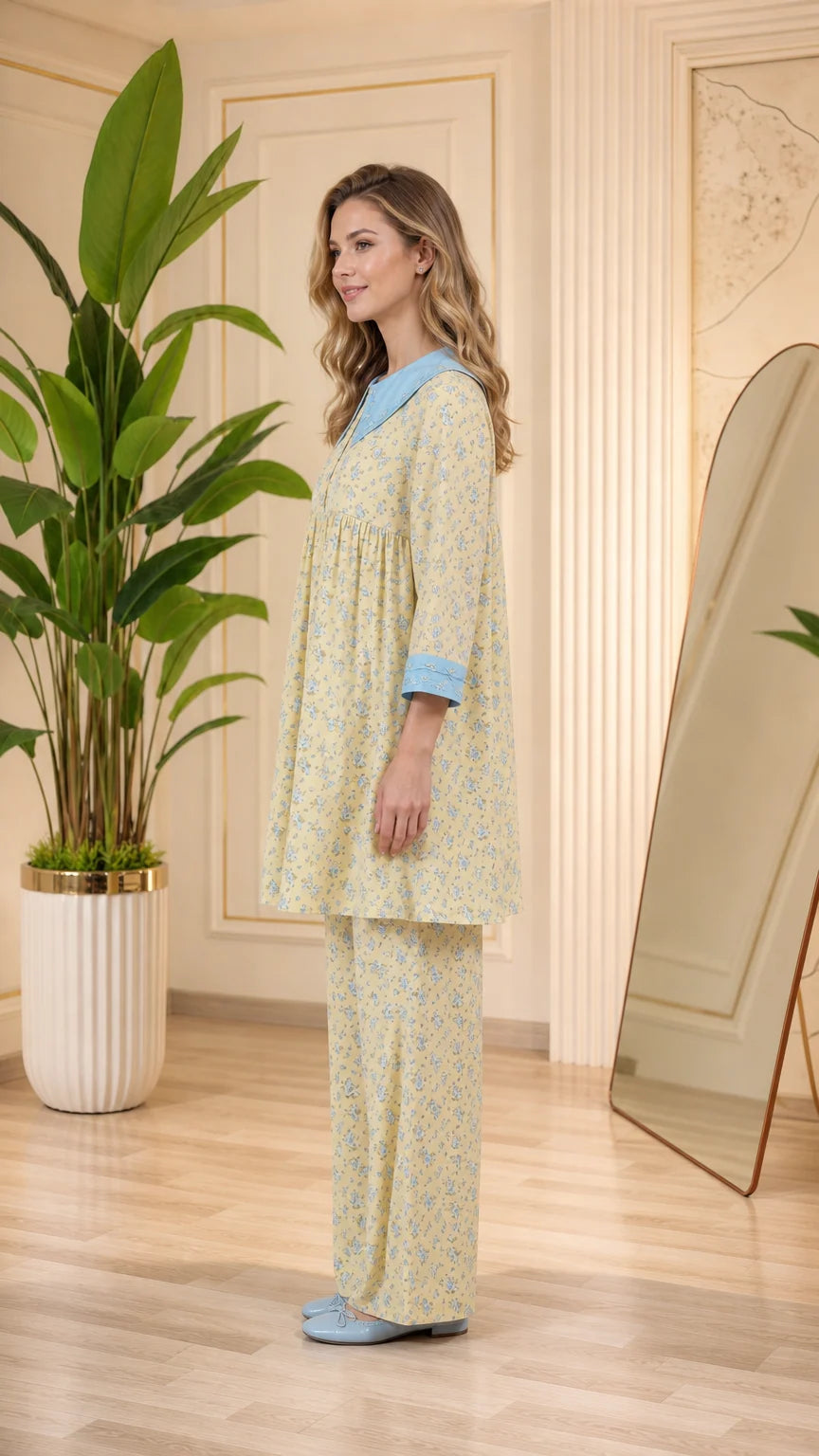 Side view of model in pastel yellow floral tunic pajama set