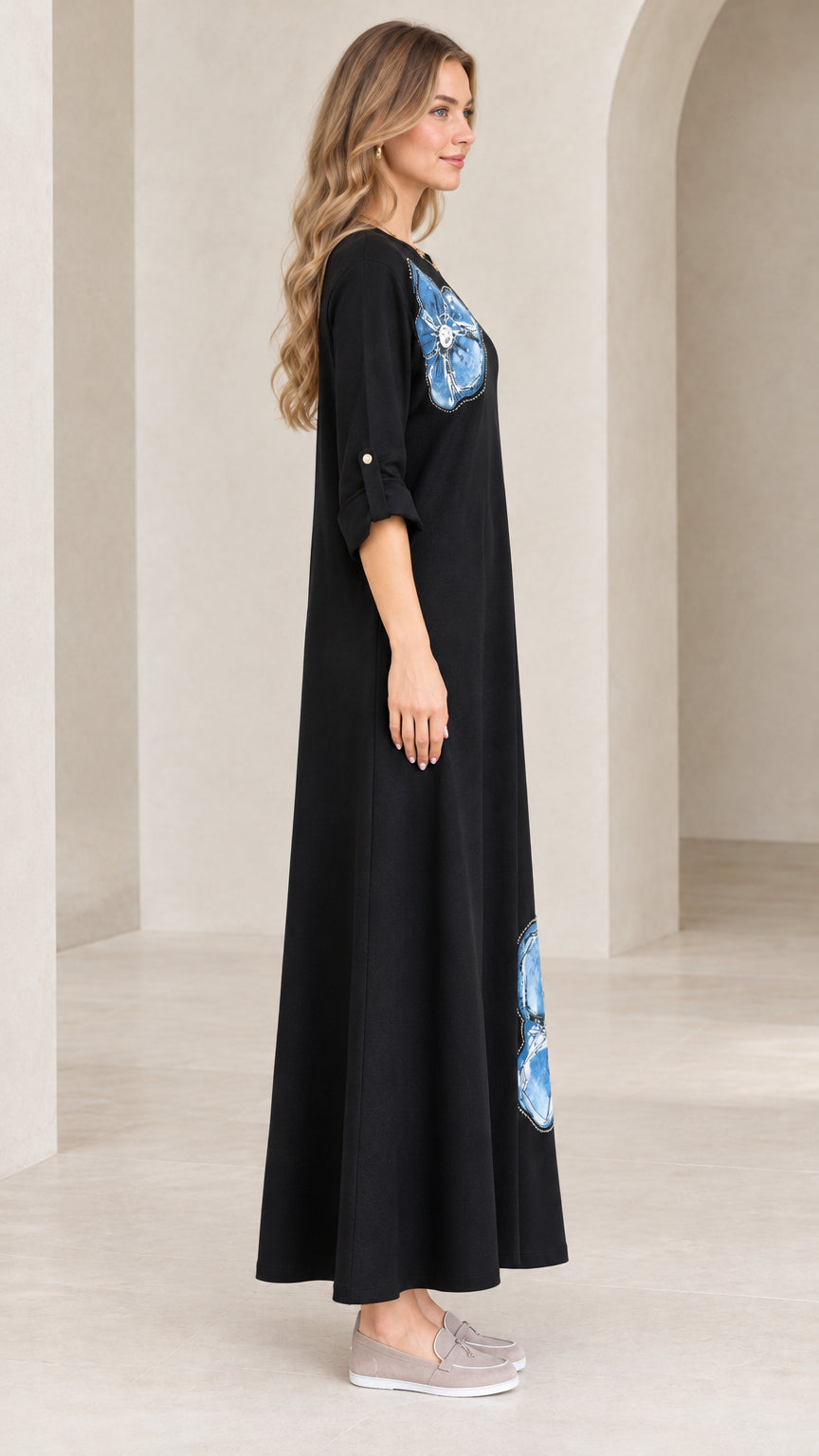 Side profile view of black round neck maxi dress with roll-tab sleeves