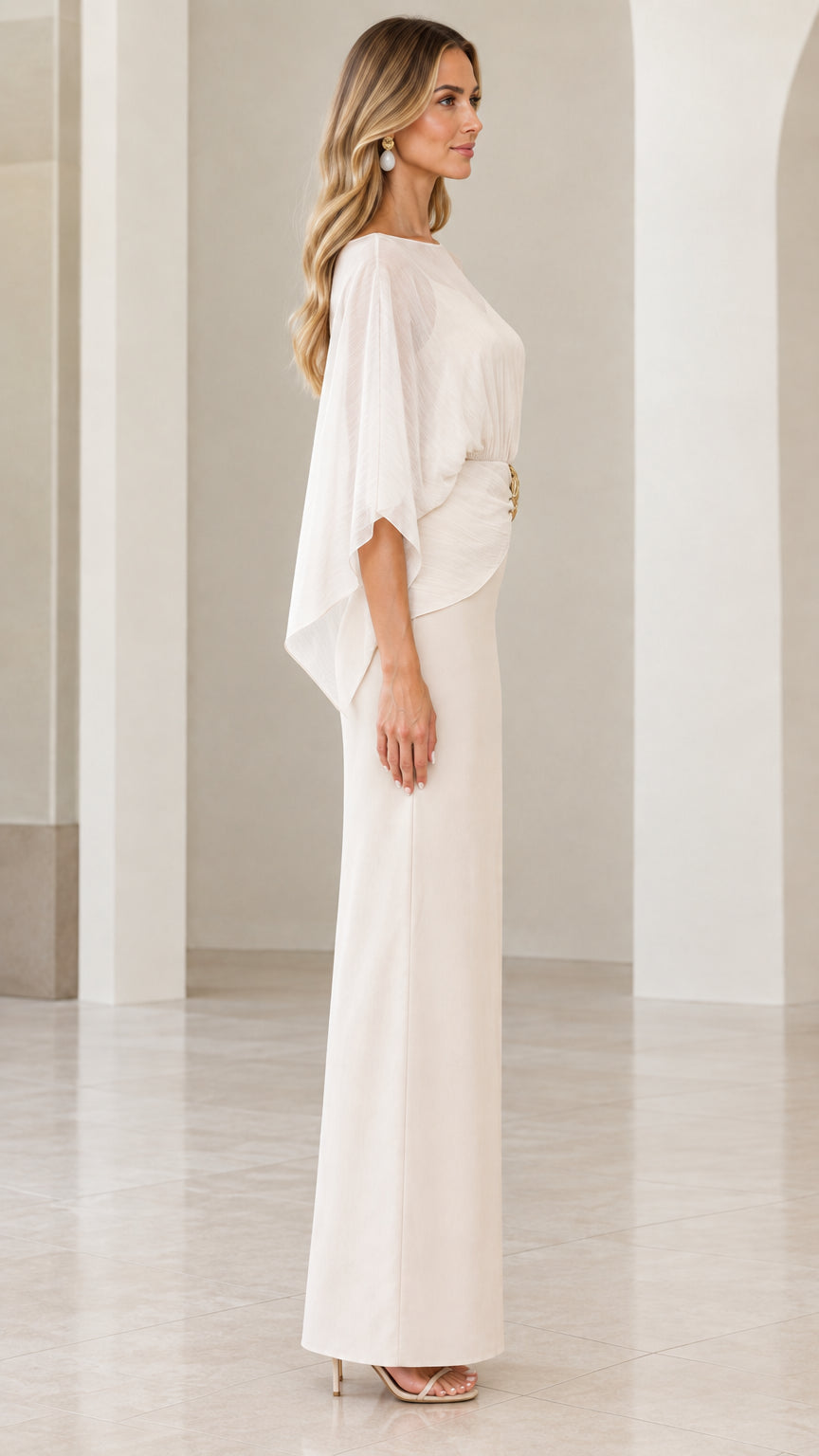 Side profile view of ivory cape overlay formal column gown
