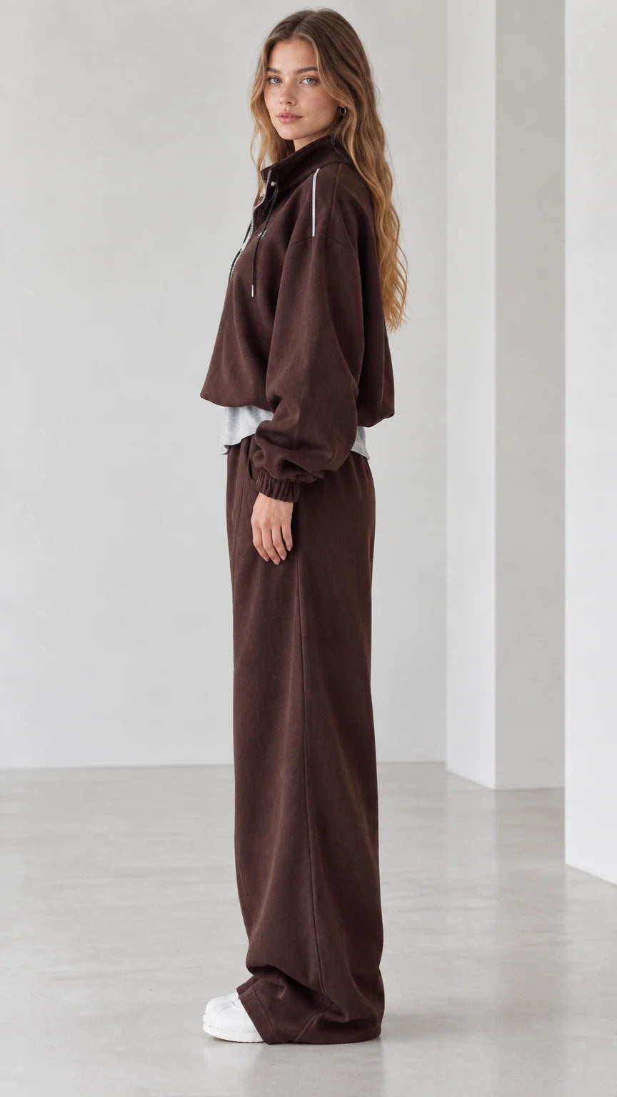 Side profile view of chocolate brown two-piece loungewear set with wide-leg pants