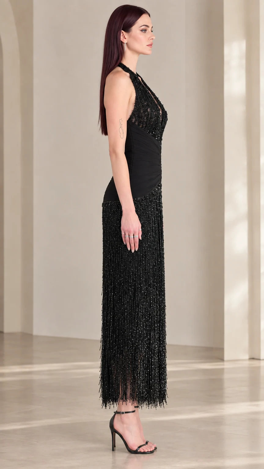 Side profile view of black halter sequin fringe dress with cinched waist