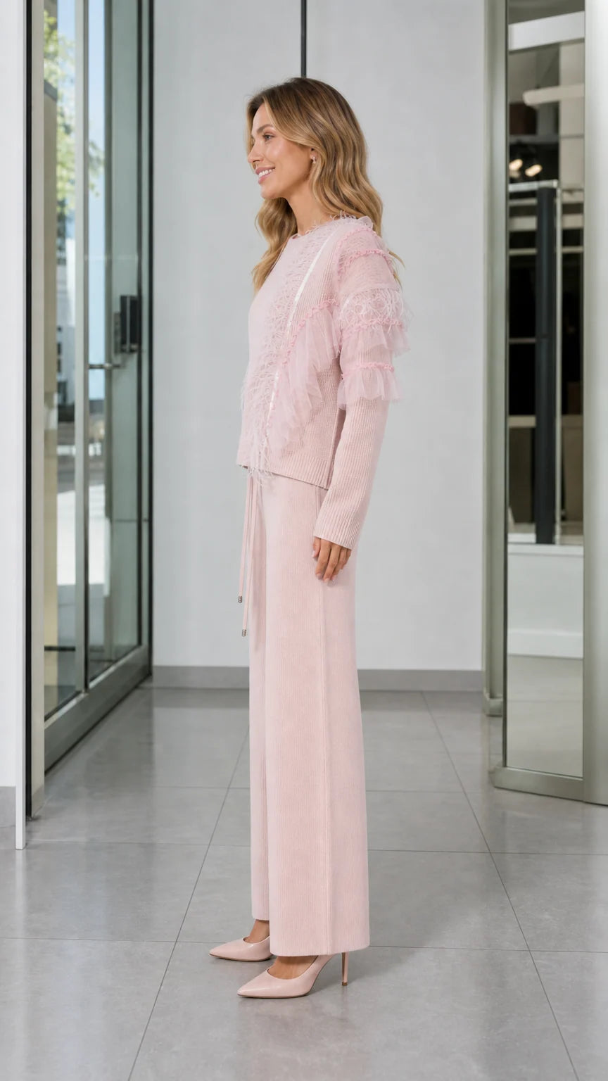 Side view of woman in Light Pink two-piece knit sweater and wide-leg trouser set