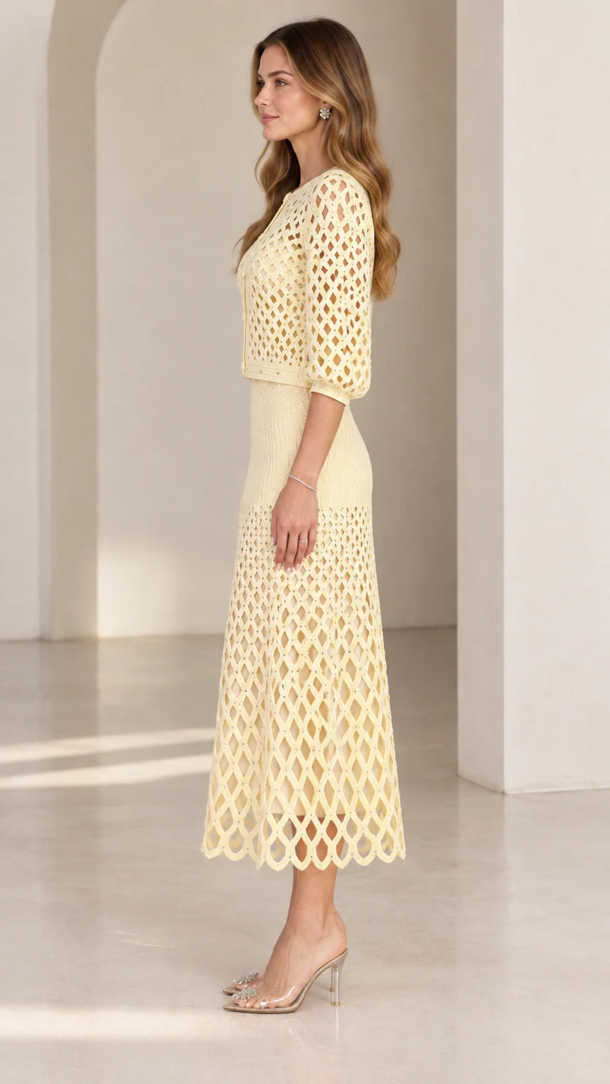Side profile view of pale yellow knit two-piece skirt set