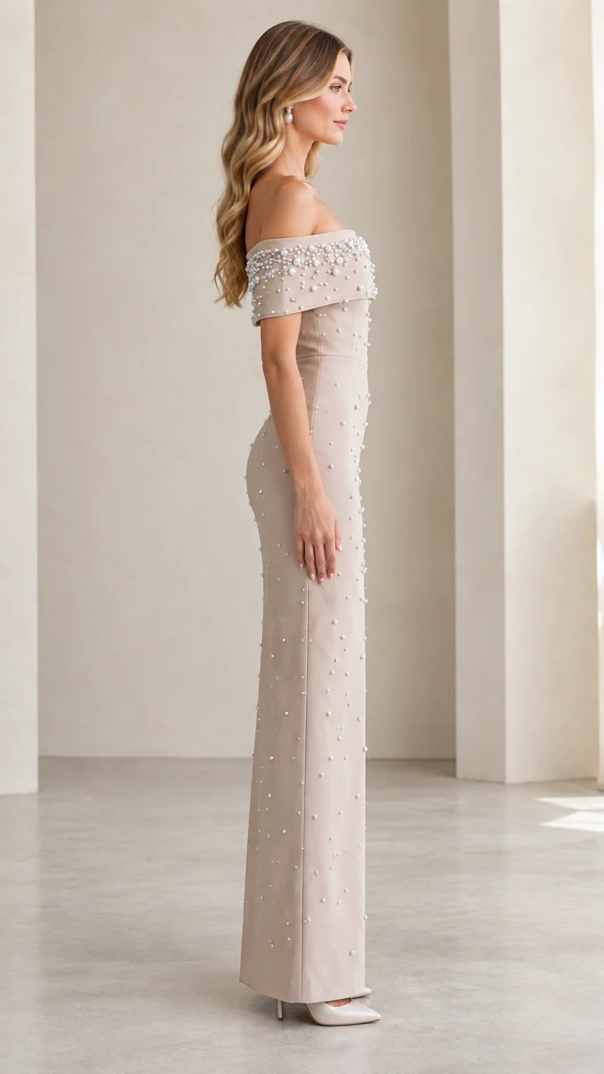 Side profile view of Champagne off-the-shoulder formal gown with pearl beading