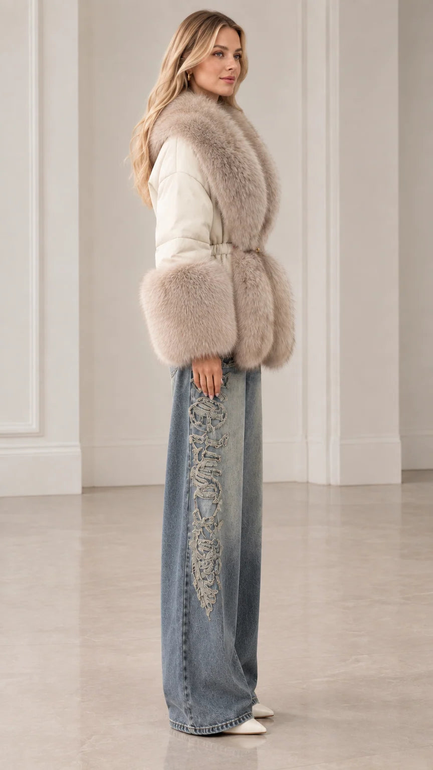 Side profile of woman modeling cream belted winter jacket with plush fur collar and cuffs
