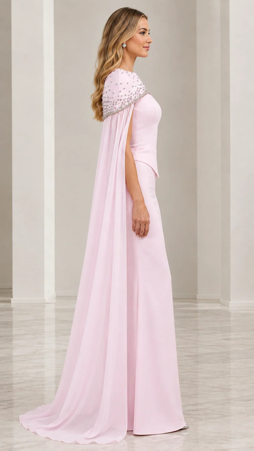 Side view of blush pink floor length gown showcasing flowy cape drape