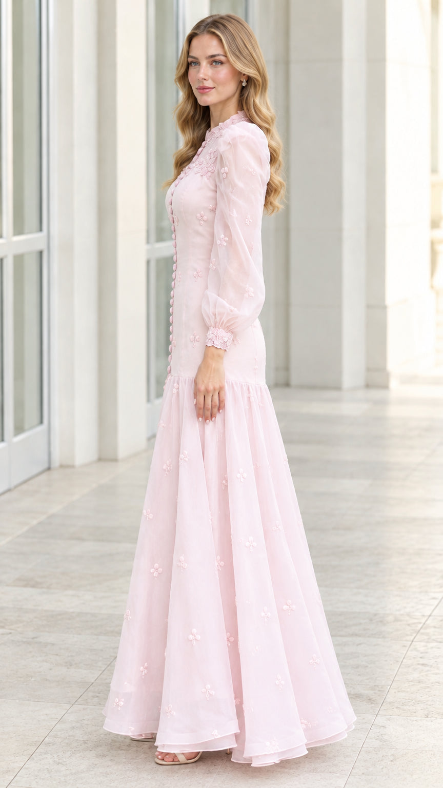 Side profile view of blush pink floral embroidered evening dress with sheer bishop sleeves