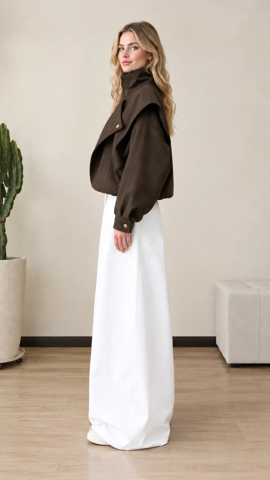 Side profile view of woman wearing dark brown structured zip jacket