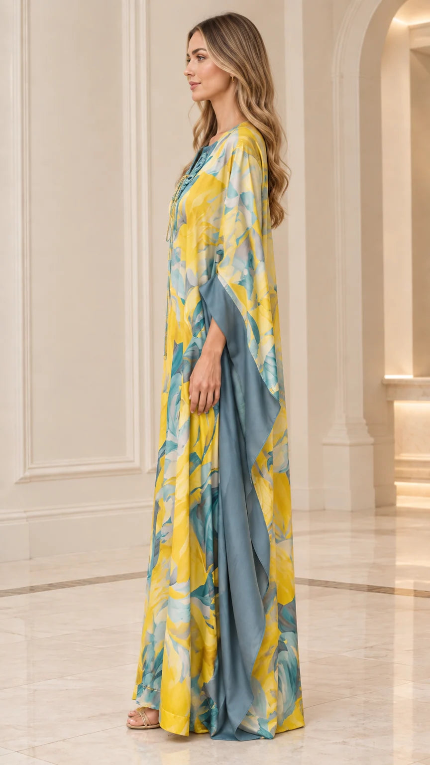 Side profile of woman in yellow floral flowing batwing caftan dress