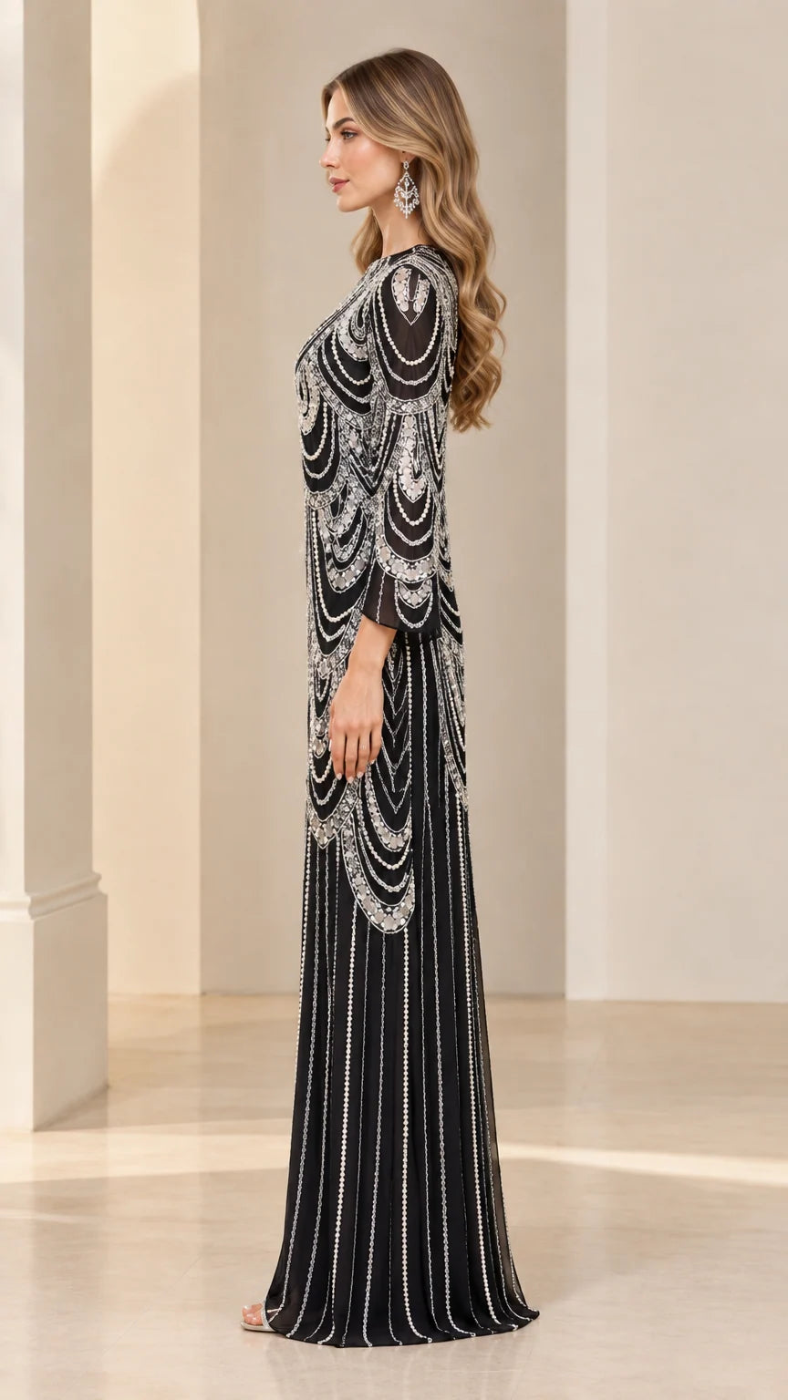 Side profile view of black beaded maxi gown showcasing flared sleeves and column drape