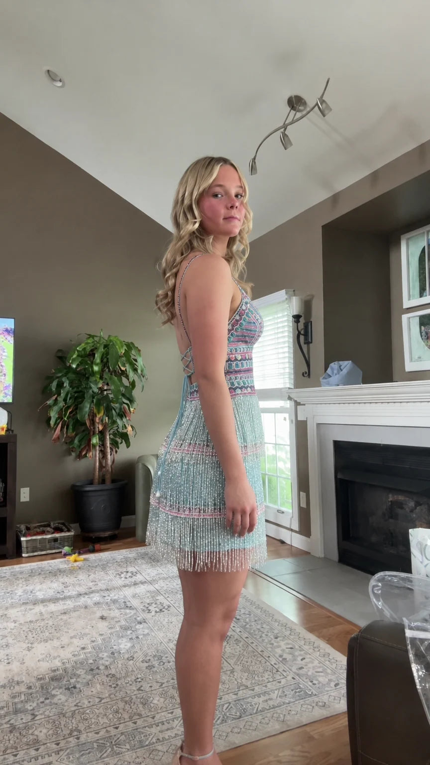 Side profile of aqua blue fringe mini party dress with delicate straps